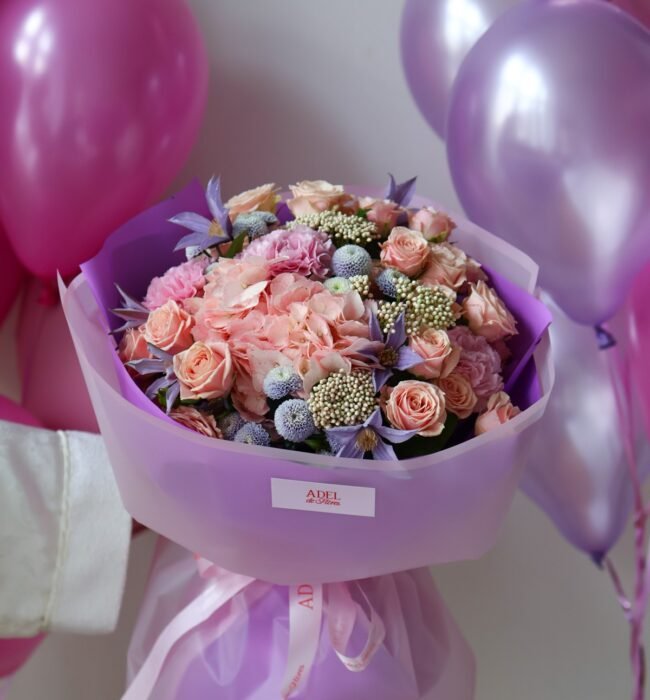 A bouquet of pink roses, carnations and hydrangeas