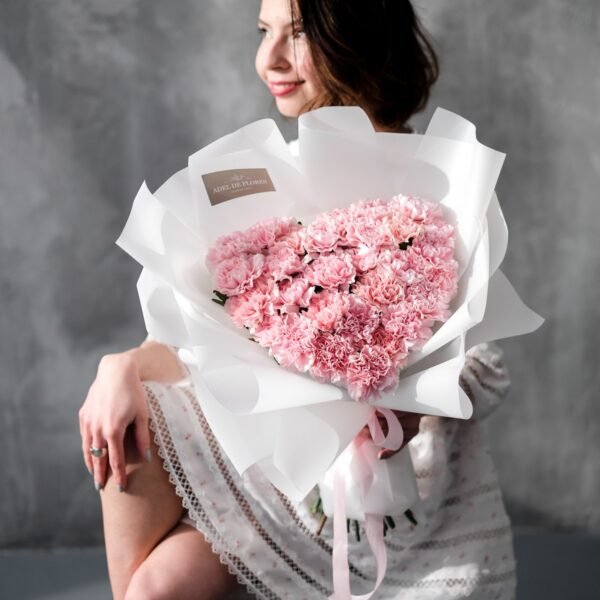 A heart-shaped bouquet of pink carnations
