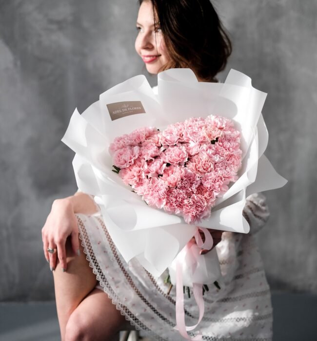 A heart-shaped bouquet of pink carnations