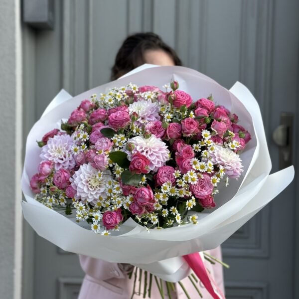 A bouquet of spray roses, dahlias and tansy