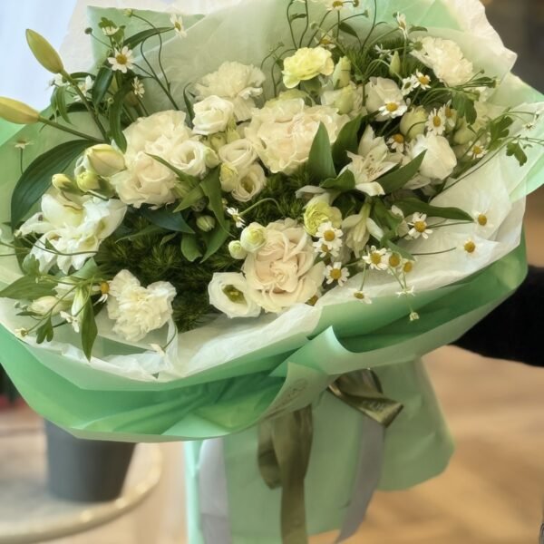 A bouquet of white roses, lilies and eustomas