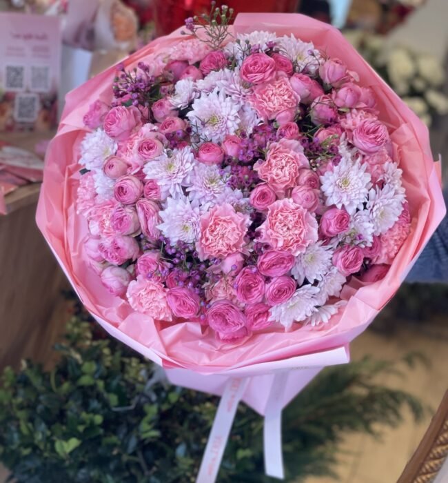 A bouquet of spray roses, carnations and chrysanthemums