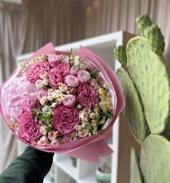 A bouquet of pink hydrangeas, peony roses and spray roses