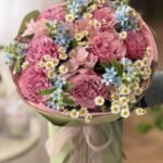 A bouquet of garden roses, alstroemerias and oxypetalums