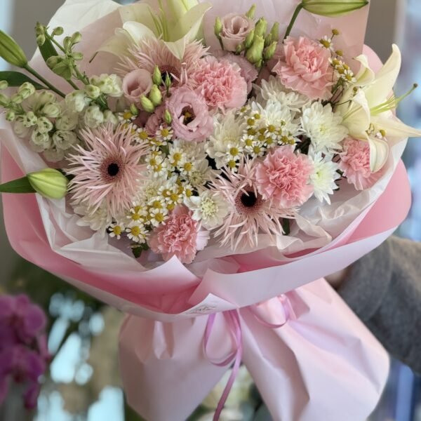 A bouquet of white lilies, carnations and eustomas