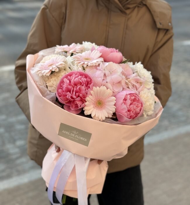 A bouquet of pink peonies, gerberas and hydrangeas